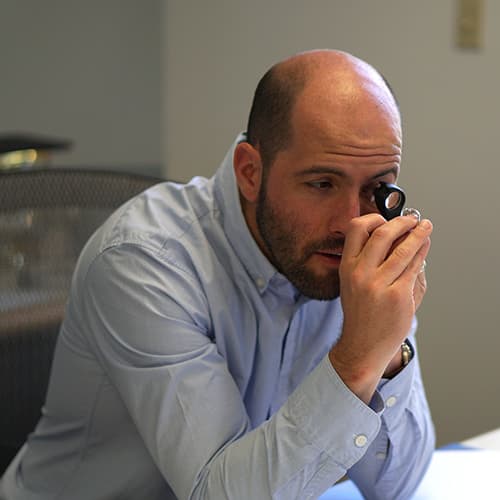 Joseph evaluating a diamond to buy.