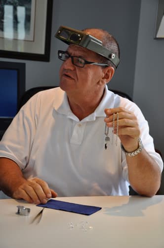 Richard Dolginow evaluating a necklace