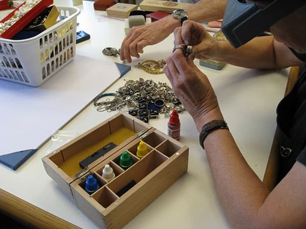 Marsha assessing the value of some gold.