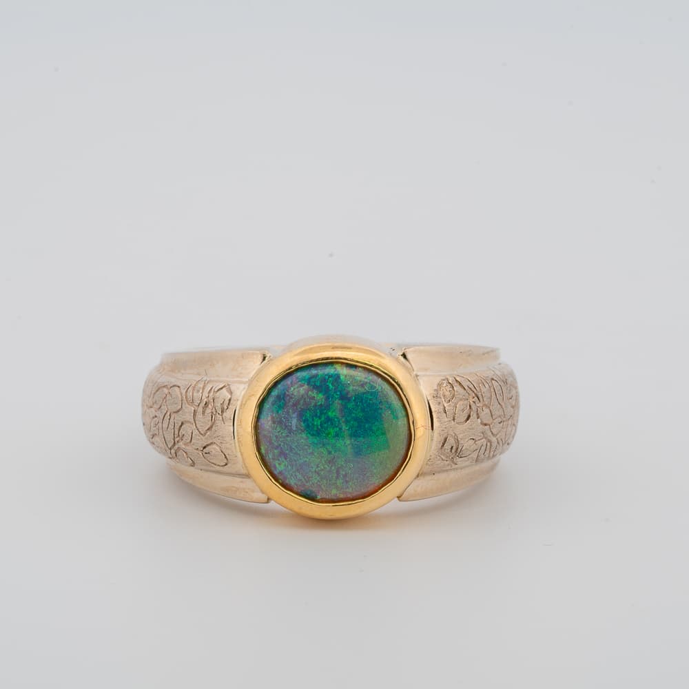 Front view of gold black opal ring