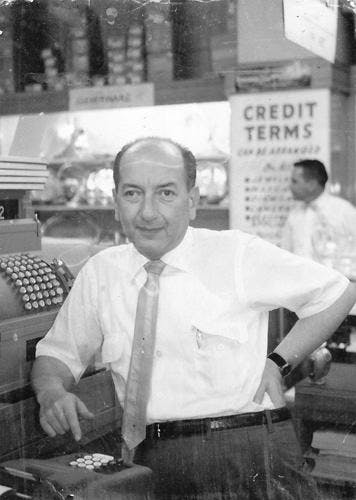 David Dolginow in front of a register at North Kansas City Dolgins store in the 1950s.