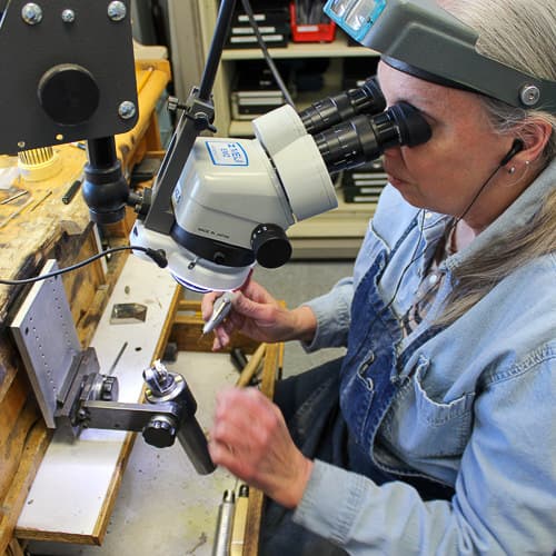 Marsha busy at the jewelers bench repairing a missing diamond.