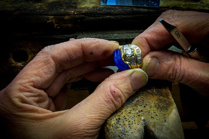 Carving a wax for a custom diamond wedding band that contours an engagement ring