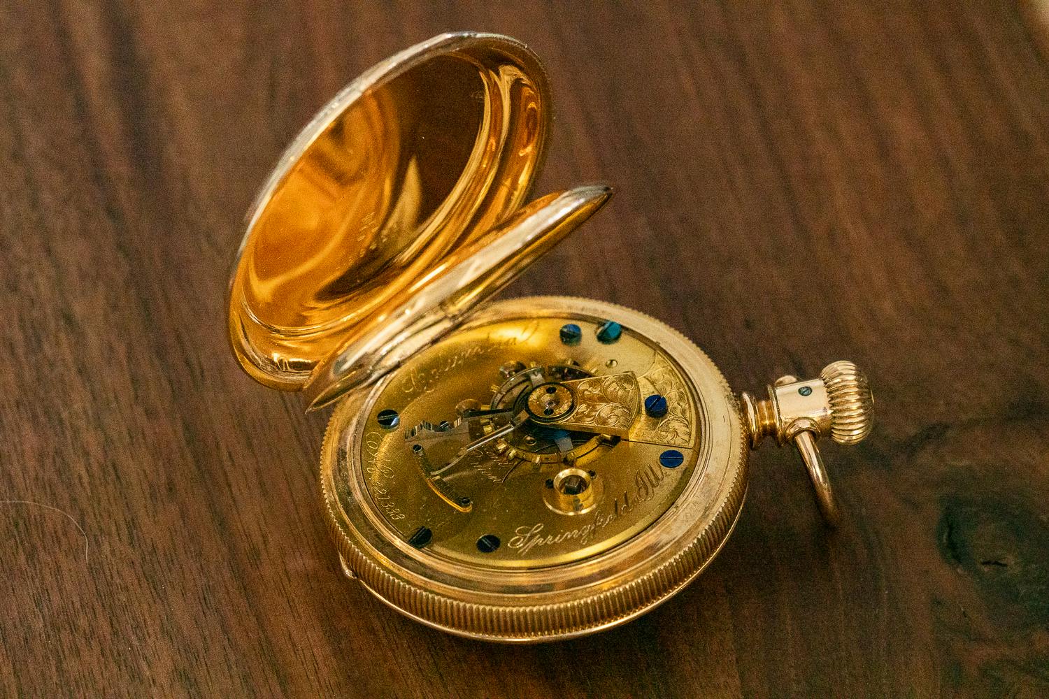 Restored pocket watch open showing the movement inside
