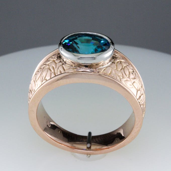 Rose gold encgraved band with 3 carat oval blue zircon - profile