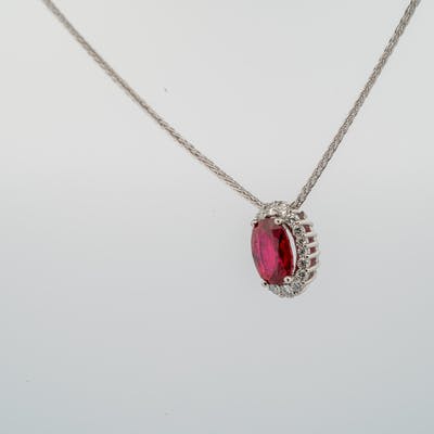 Ruby graduated halo diamond pendant in platinum back view