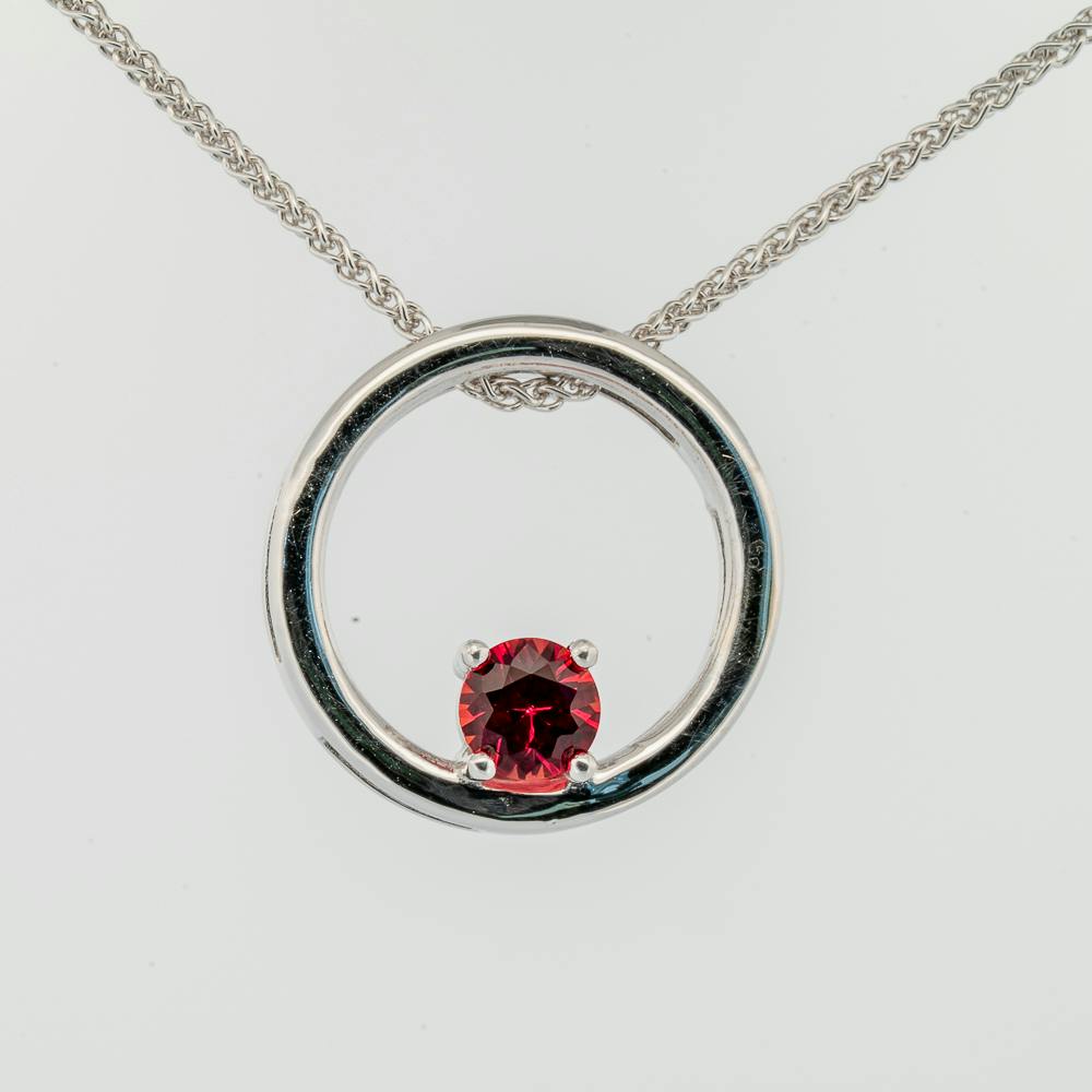 Front view of red sapphire round pendant