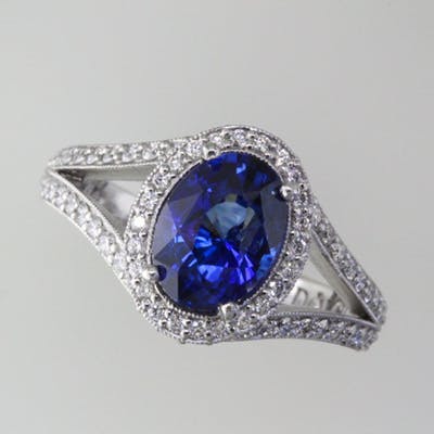 Top view of the platinum split shank halo ring set with a blue sapphire