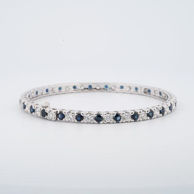 View of the entire sapphires in diamond and sapphire bangle bracelet