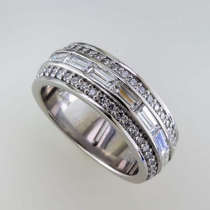 Side view of wide baguette and round platinum ring