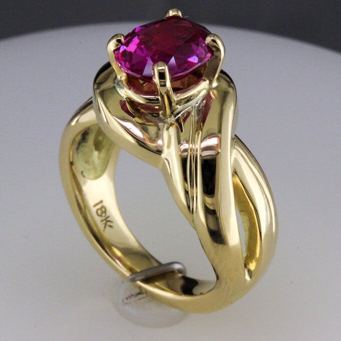 3/4 view of 18 karat yellow gold pink sapphire ring