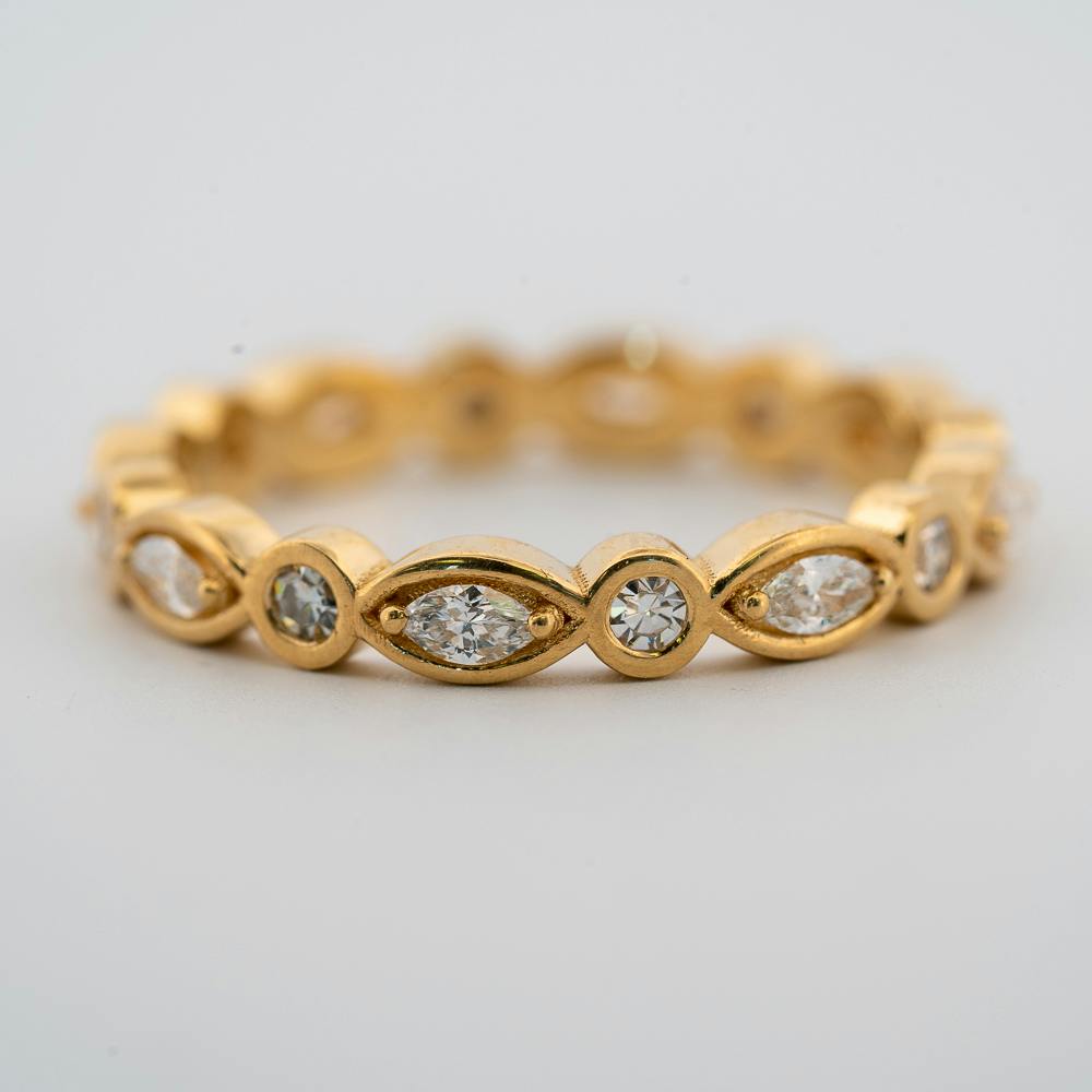Front view of 18 karat yellow gold round and marquise diamond eternity band with grandma's diamonds