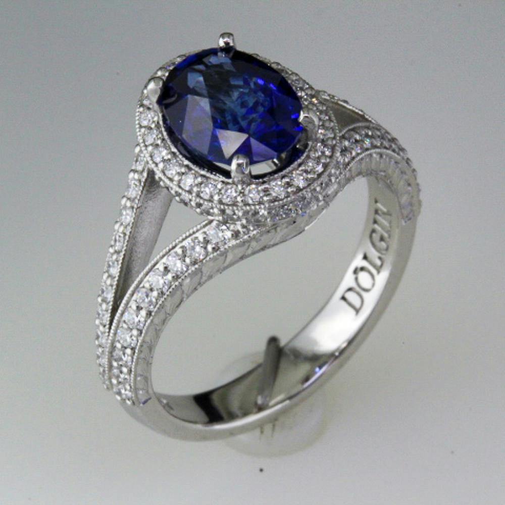 Side view of the platinum split shank halo ring set with a blue sapphire