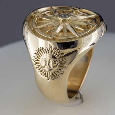 View of custom marine compass ring with the Sun